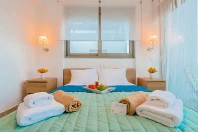 a bedroom with a bed with towels on it at Filoxenia Villas in Gennadi