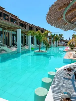 a large swimming pool with chairs and a building at Alia Suites and Spa in Haraki