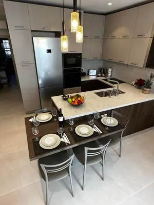 a kitchen with a island with a table and chairs at Samanthas LUXURY APARTMENT in Haraki