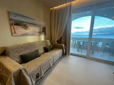 a living room with a couch and a view of the ocean at Samanthas LUXURY APARTMENT in Haraki