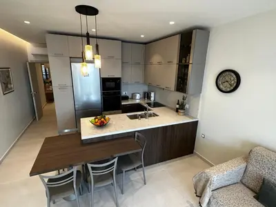 a kitchen with a dining table and a counter top at Samanthas LUXURY APARTMENT in Haraki