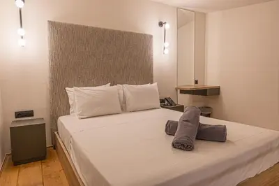 a bedroom with a large white bed with two pillows at Haraki Luxury Villas in Haraki