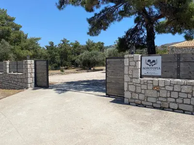 a gate to a zoo with a sign on it at AGROTOPIA Guesthouses in Theologos