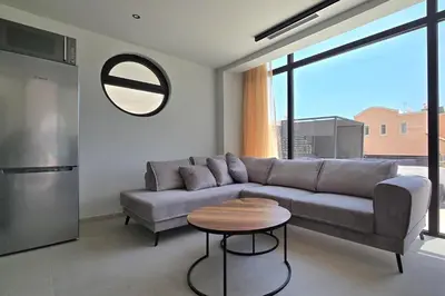 a living room with a couch and a table at Trapezia Luxury Living in Kolimbia