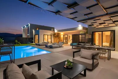 a living room with a pool and a house at Trapezia Luxury Living in Kolimbia
