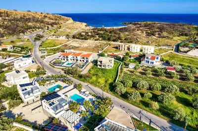 an aerial view of a house and the ocean at Villa Apollon Lindian Palm by Villa Plus in Kiotari