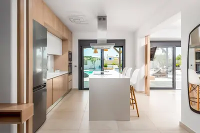 a kitchen with a white island in a room at Villa Apollon Lindian Palm by Villa Plus in Kiotari