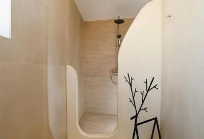 a bathroom with a shower with a black tree sticker at 5 SENSES in Pefki Rhodes