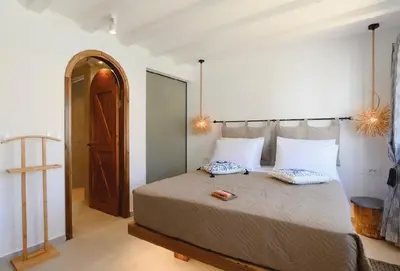 a bedroom with a large bed with two pillows on it at 5 SENSES in Pefki Rhodes