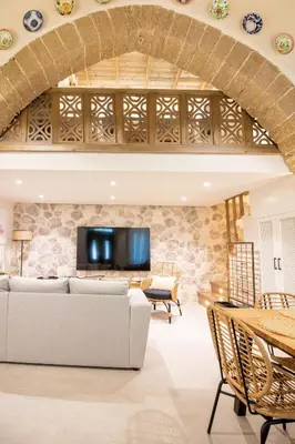 a living room with a couch and a tv at Mounouria House Koskinou in Koskinou