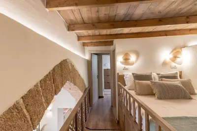 a bedroom with a large bed and wooden ceilings at Mounouria House Koskinou in Koskinou