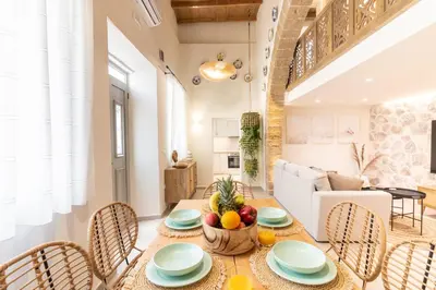 a kitchen and living room with a table and chairs at Mounouria House Koskinou in Koskinou