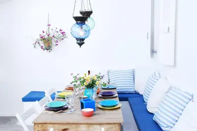 a blue table with plates and dishes on it at seasalthouse - famous tv location in Koskinou