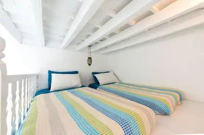 two beds sitting next to each other in a room at seasalthouse - famous tv location in Koskinou
