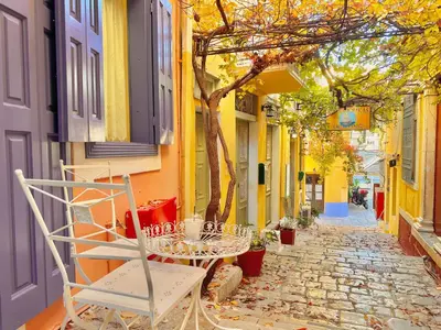 a table and chairs sitting on a cobblestone street at Kali Strata 1 - Downtown in Symi