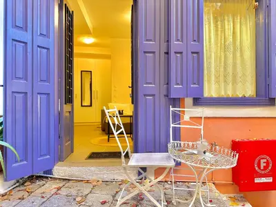 a room with purple doors and a table and a chair at Kali Strata 1 - Downtown in Symi