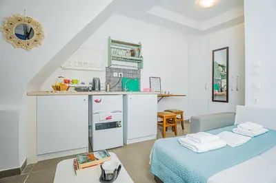 a living room with a bed and a kitchen at Kali Strata 1 - Downtown in Symi