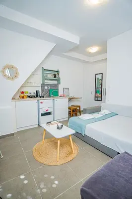 a bedroom with two beds and a coffee table at Kali Strata 1 - Downtown in Symi