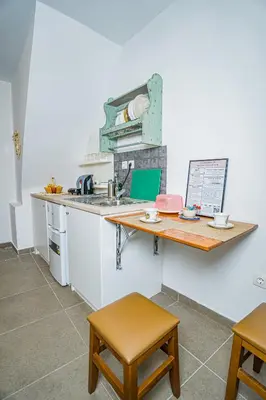 a kitchen with a counter and a sink and a table at Kali Strata 1 - Downtown in Symi
