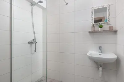a white bathroom with a sink and a shower at Villa Katerina - Soroni in Rhodes Town