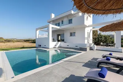 a villa with a swimming pool in front of a house at Villa Katerina - Soroni in Rhodes Town