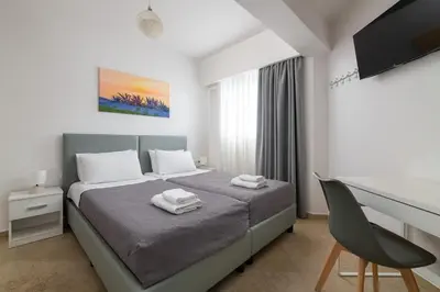 a bedroom with a bed with two towels on it at Aegean Retreat Luxury Apartment in Rhodes Town