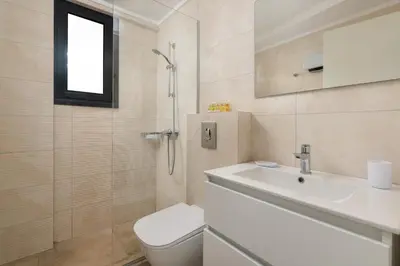 a bathroom with a sink and a toilet and a shower at Aegean Retreat Luxury Apartment in Rhodes Town