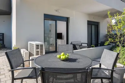 a table with a bowl of fruit on a patio at Aegean Retreat Luxury Apartment in Rhodes Town