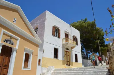 a group of people standing outside of a building at Villa Pavlos in Symi