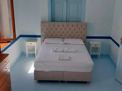 a bedroom with a bed with two towels on it at Villa Pavlos in Symi