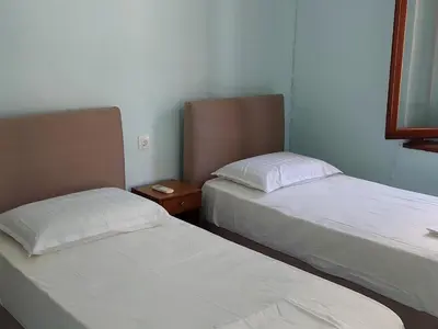 two beds sitting next to each other in a room at Villa Pavlos in Symi