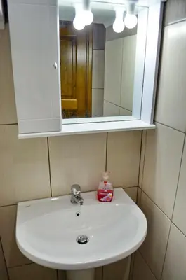 a bathroom sink with a medicine cabinet above it at Villa Pavlos in Symi