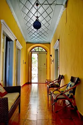 a living room with chairs and a couch and a ceiling at Villa Pavlos in Symi