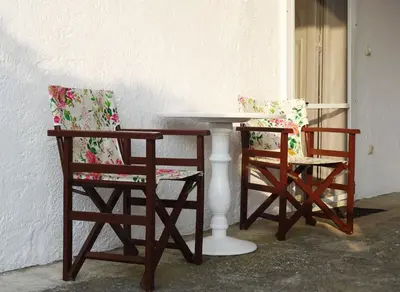 two chairs and a table and a table and chairs at Nadia's House 1 in Afantou