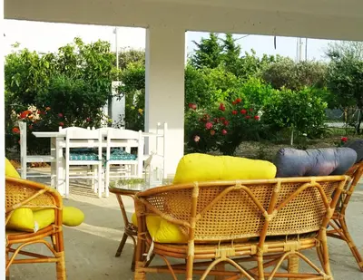 a patio with chairs and a table and a table and chairs at Nadia's House 1 in Afantou