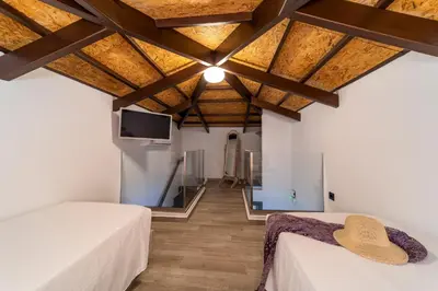 a room with two beds and a flat screen tv at Anastasia Deluxe Studio in Kattavía