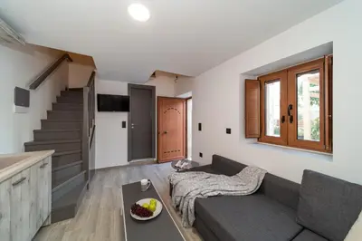 a living room with a couch and a table at Anastasia Deluxe Studio in Kattavía