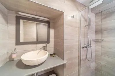 a bathroom with a sink and a shower at Anastasia Deluxe Studio in Kattavía