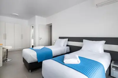 two beds sitting next to each other in a bedroom at Villa Zoe Blu in Kalathos