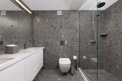 a bathroom with a toilet and a glass shower at Villa Zoe Blu in Kalathos