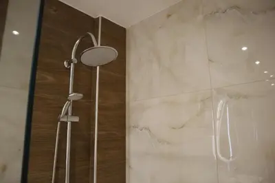 a shower with a glass door in a bathroom at Merelia Luxury Guesthouse in Haraki