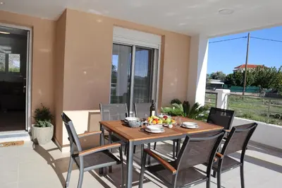 a dining room with a table and chairs at Merelia Luxury Guesthouse in Haraki