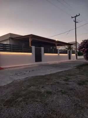 a white building with a sign on the side of it at Summer holidays in Kolimbia