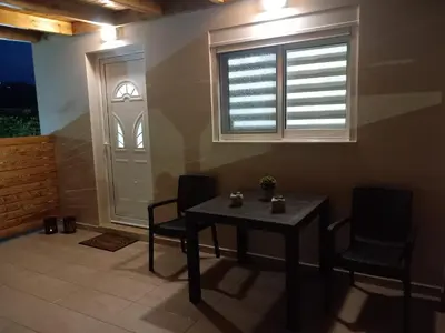 a dining room with a table and chairs and a window at Summer holidays in Kolimbia