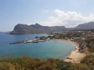 a view of a beach with mountains in the background at Summer holidays in Kolimbia