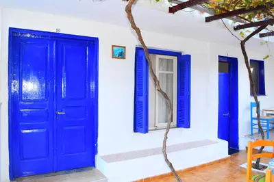 a blue door and windows on a white wall at Stathis in Rhodes Town