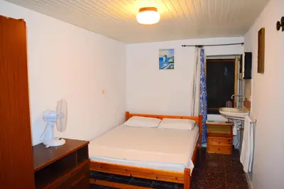 a small bedroom with a bed and a sink at Stathis in Rhodes Town