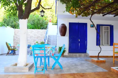 a blue table and chairs in front of a blue door at Stathis in Rhodes Town