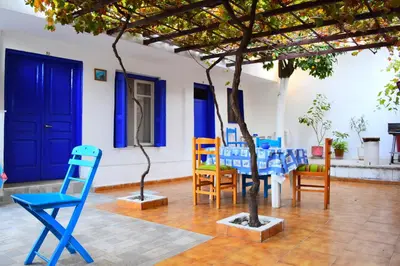 a group of chairs and a tree in a room at Stathis in Rhodes Town