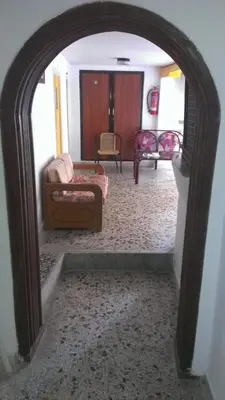 an archway into a living room with a couch and a chair at Stathis in Rhodes Town